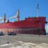 Red Ship Pulled by Tugboat